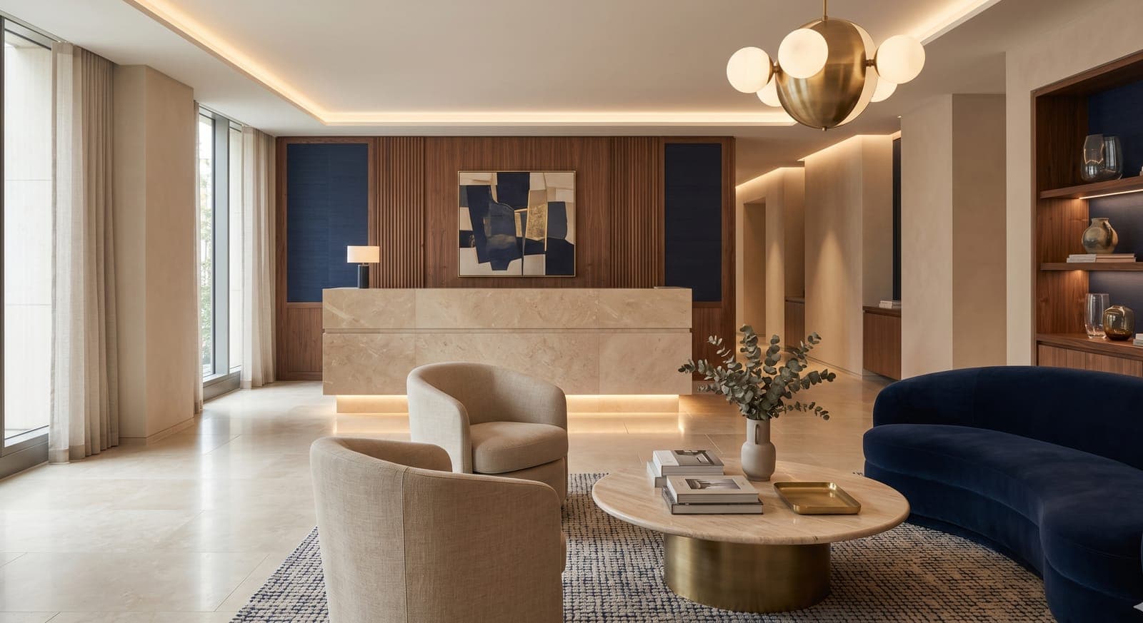 Reception with a travertine desk, walnut panelling, indigo wall panels and a brass pendant
